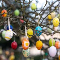 Tree decorated with colorful Easter eggs, street Easter decor.